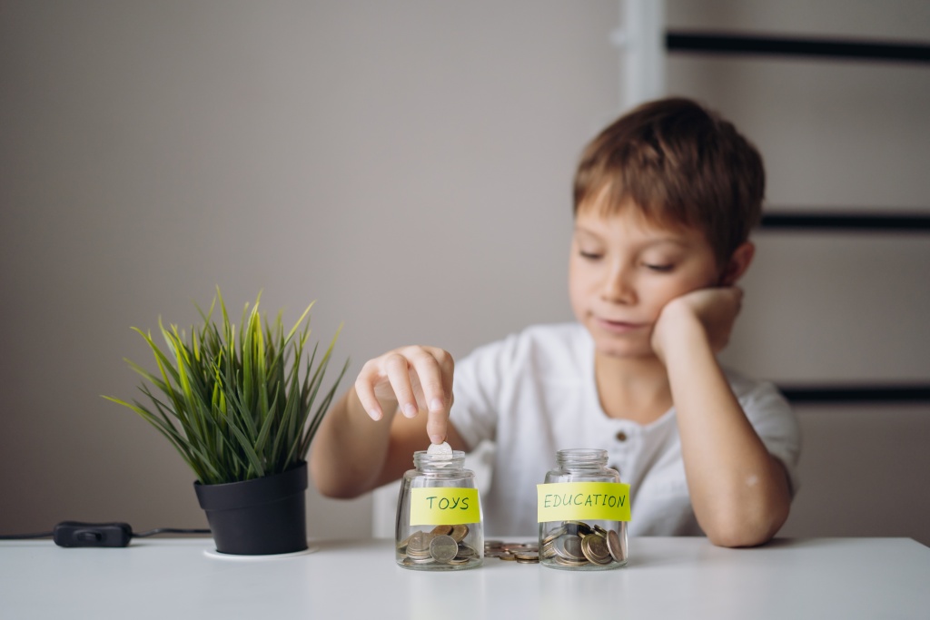 little-caucasian-boy-putting-coin-into-glass-bottle-table-kid-saving-money-future-concept-image-with-selective-focus.jpg цветок